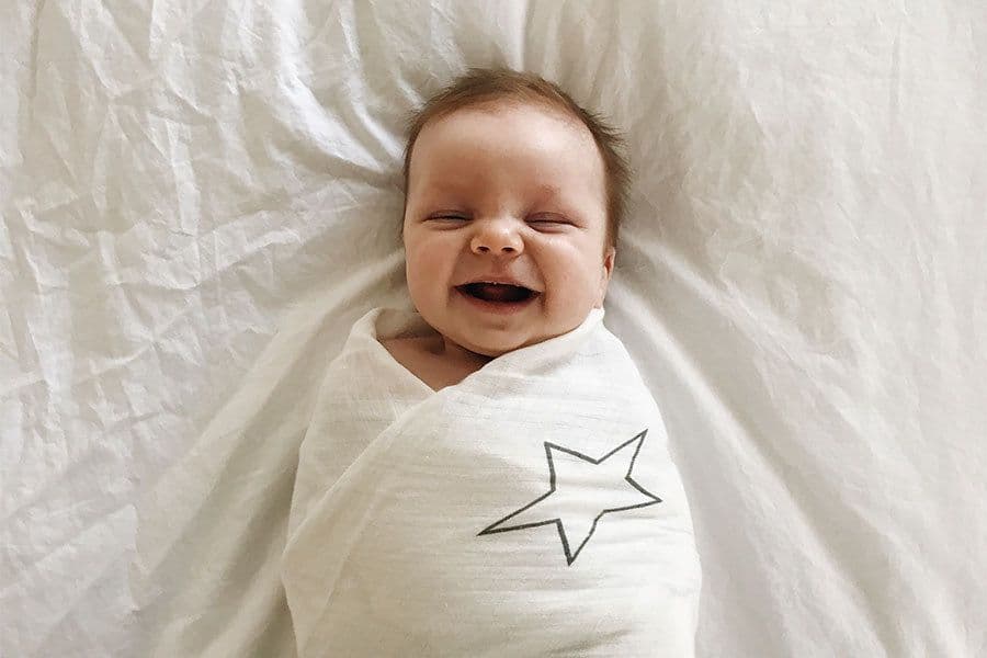 smiling swaddled baby