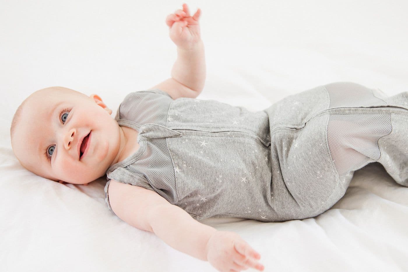 Cute baby in a graphite stars Sleepea swaddle